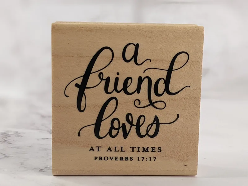 A religious rubber stamp with a Bible verse: A Friend Loves At All Times